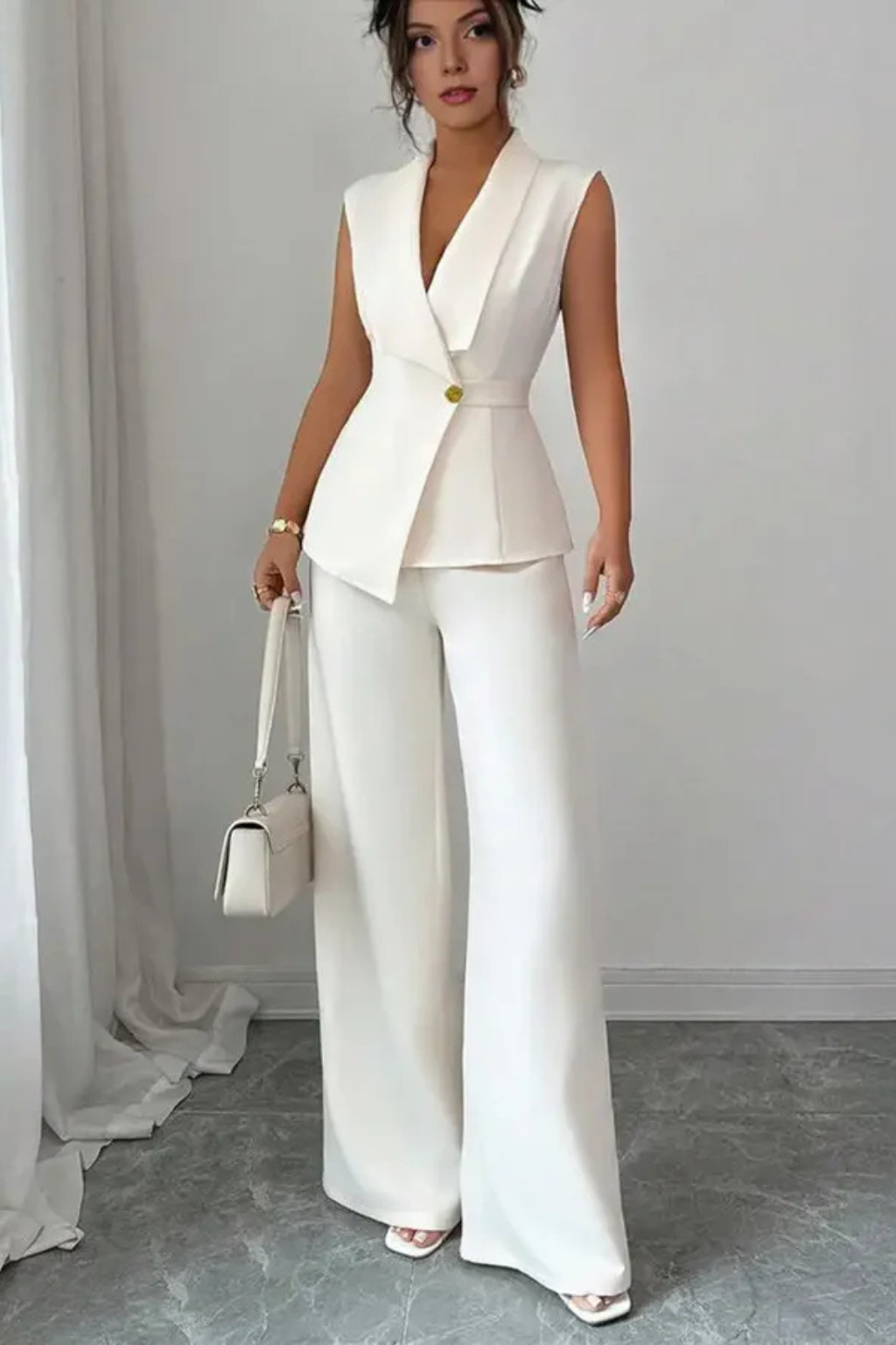 Crisp white women's V-neck sleeveless blazer and wide-leg trousers suit set. Ideal for professional settings.