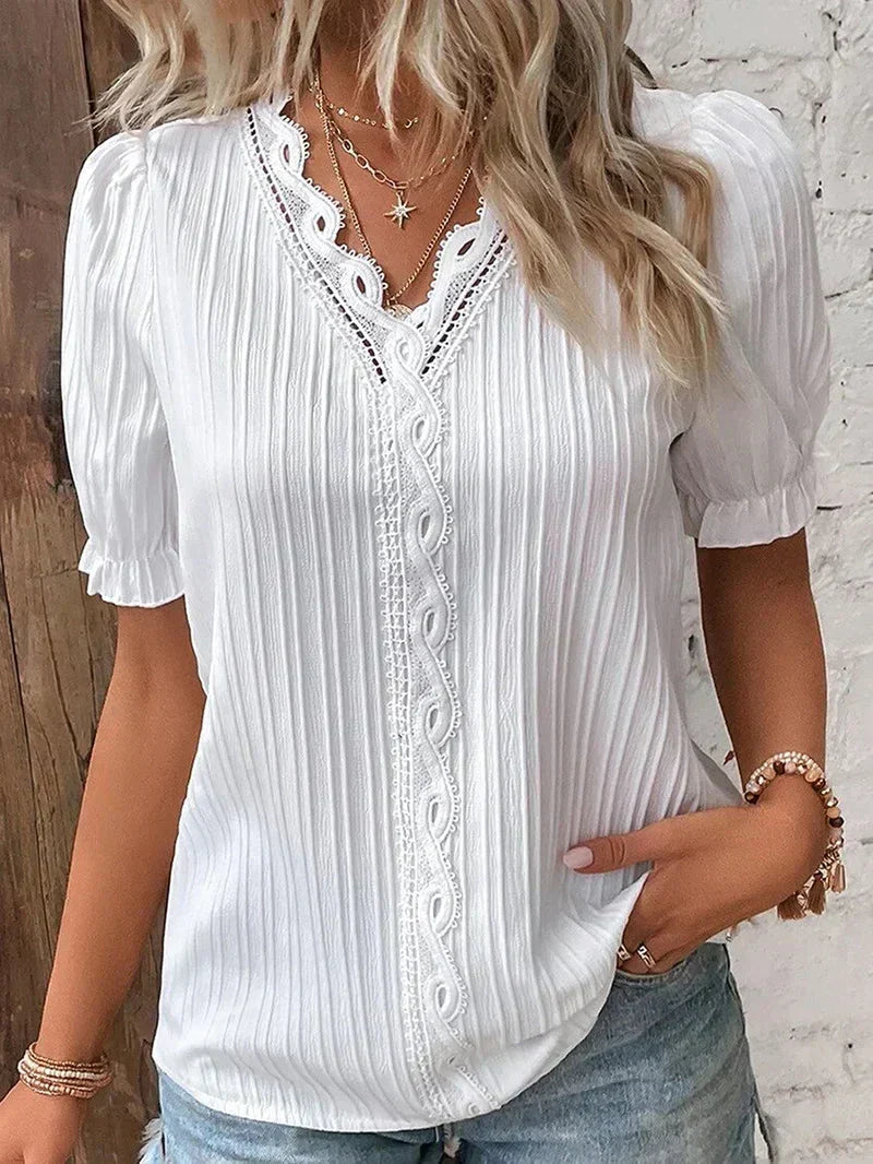 Elegant white women's V-neck blouse with delicate pleats and button detail, perfect for casual chic or office wear.