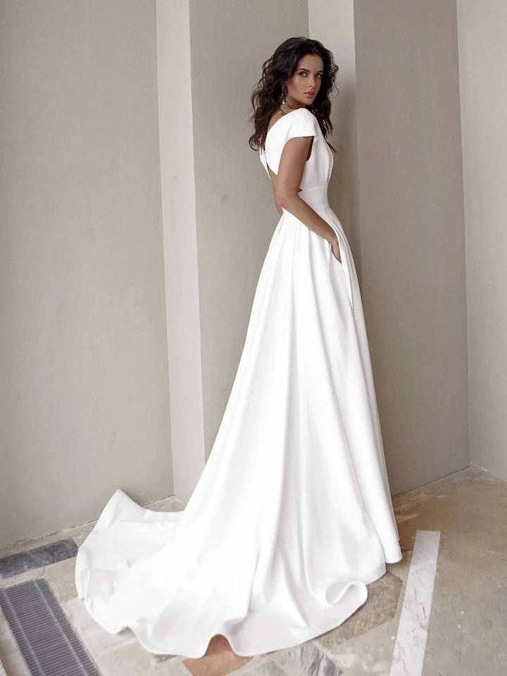 Sophisticated women's V-neck white gown featuring a high slit & floor-length design for glamorous special occasions.