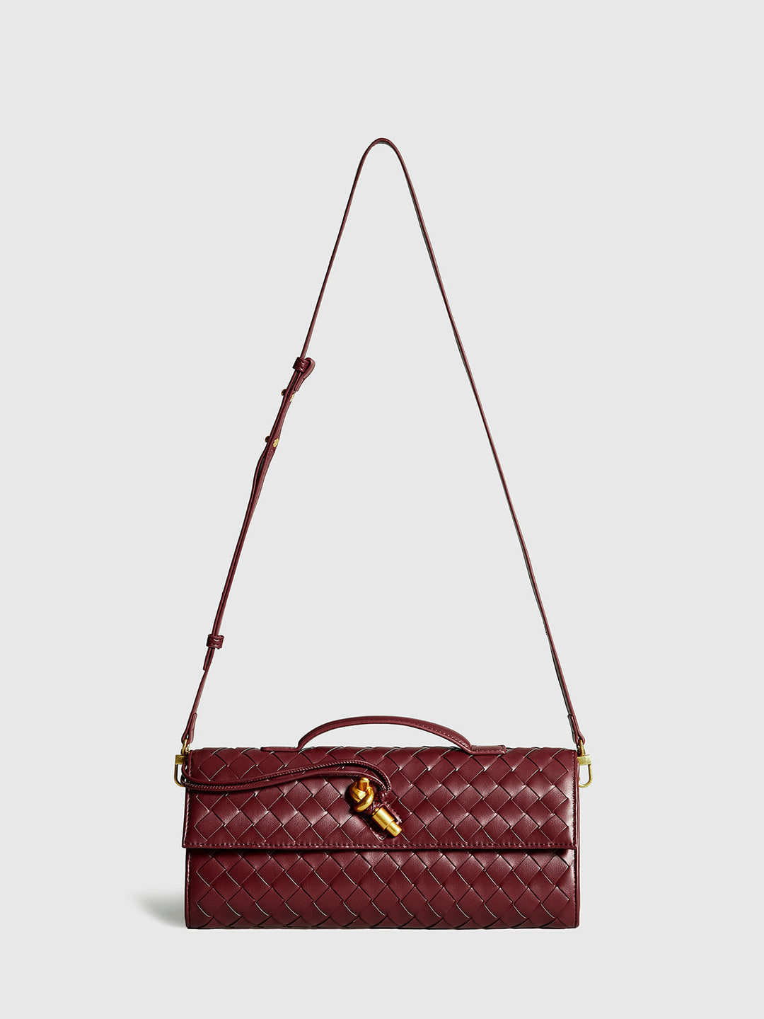 Stylish wine red woven clutch bag for women. Elegant evening purse with a chic flap design & magnetic closure.