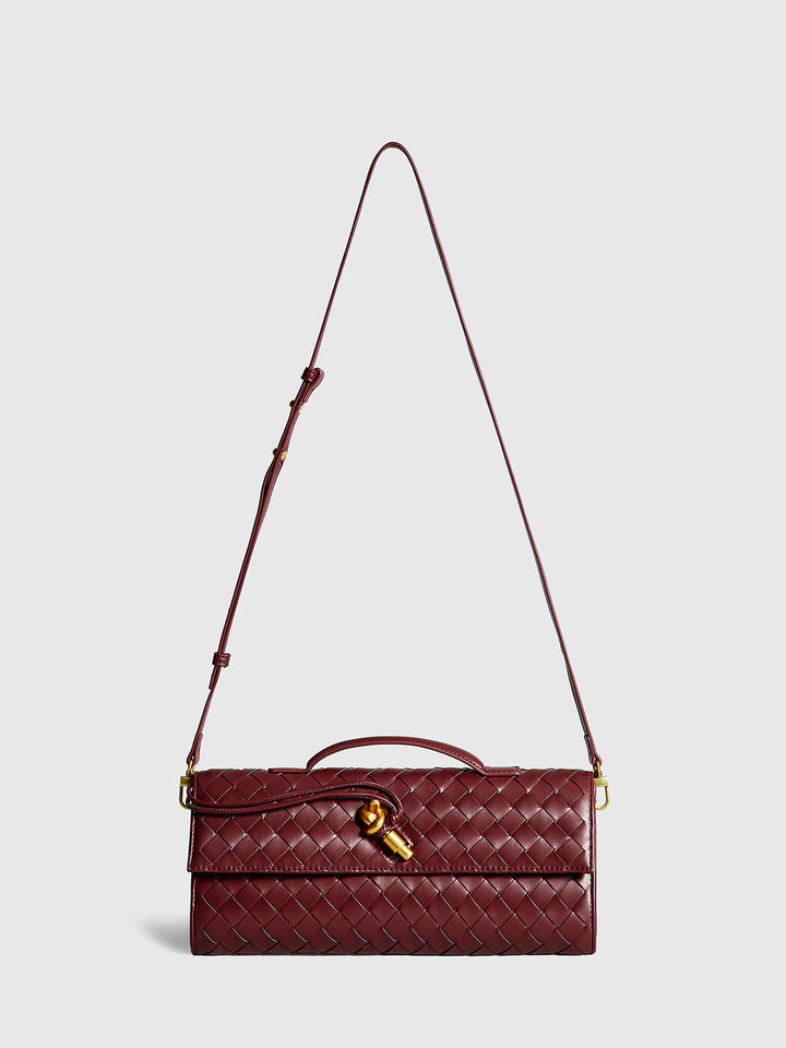 Stylish wine red woven clutch bag for women. Elegant evening purse with a chic flap design & magnetic closure.