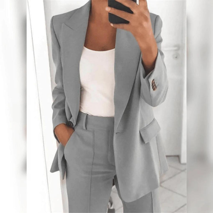 Professional women's office wear. Smart blazer and trousers set, a coordinated and elegant business outfit.