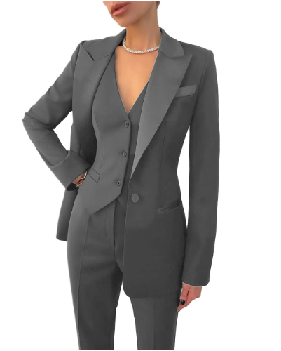 Woman wearing an elegant 3-piece suit: tailored blazer, vest, trousers for a sharp professional look.