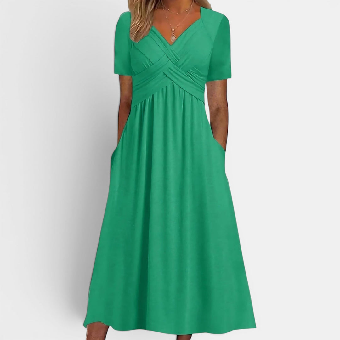 Comfortable short sleeve A-line midi dress for women, featuring a sophisticated look & convenient pockets.