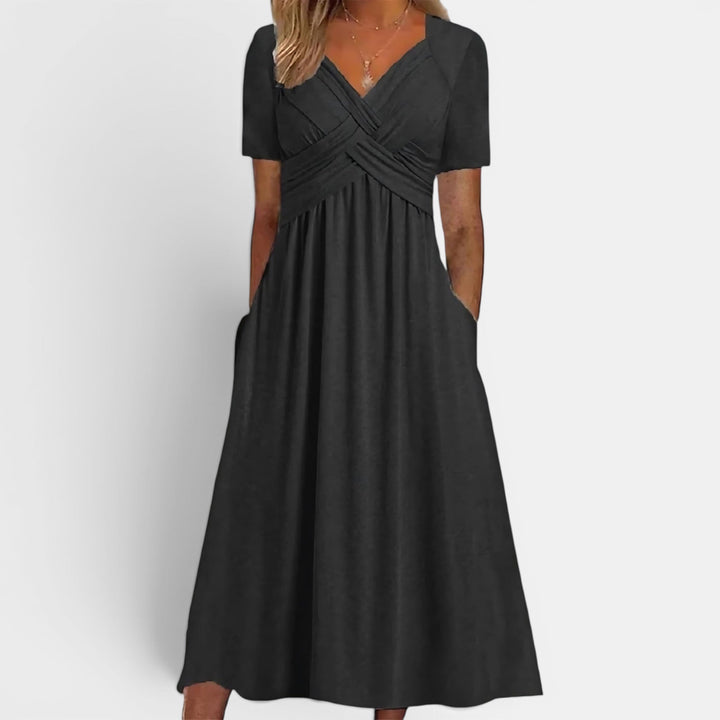 Versatile elegant women's midi dress. Short sleeve A-line cut, ideal for casual or sophisticated everyday wear.