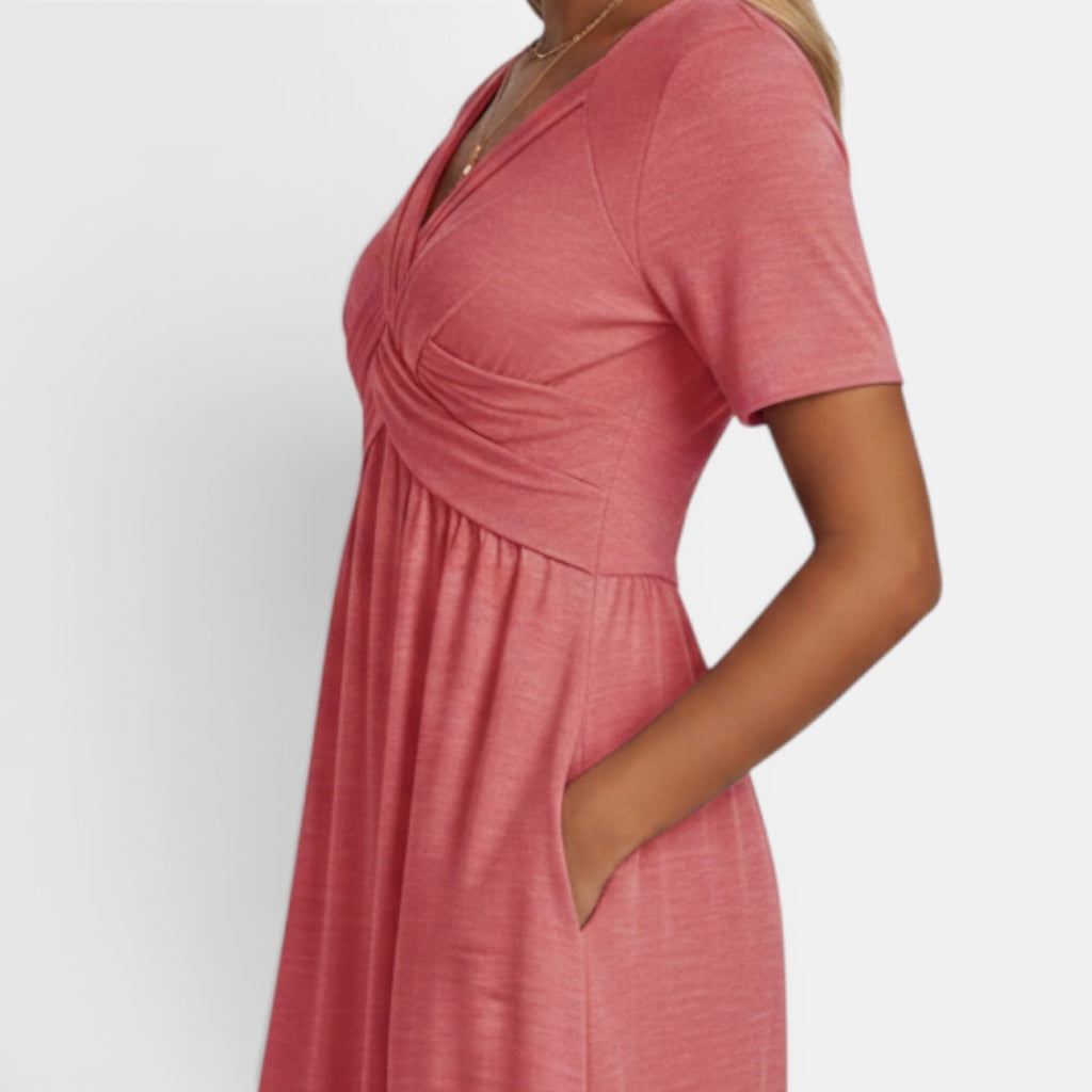 Women's elegant short sleeve midi dress. A-line cut, comfortable fabric, and practical pockets for any occasion.
