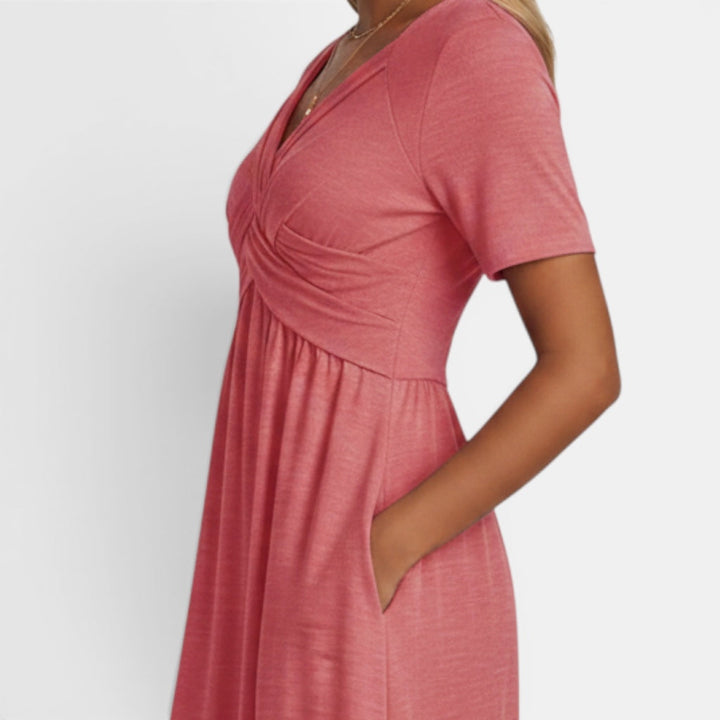 Women's elegant short sleeve midi dress. A-line cut, comfortable fabric, and practical pockets for any occasion.
