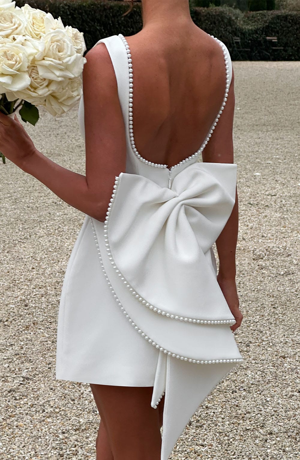 Versatile elegant A-line mini dress with pearl trim for women, suitable for wedding guests or cocktail parties.