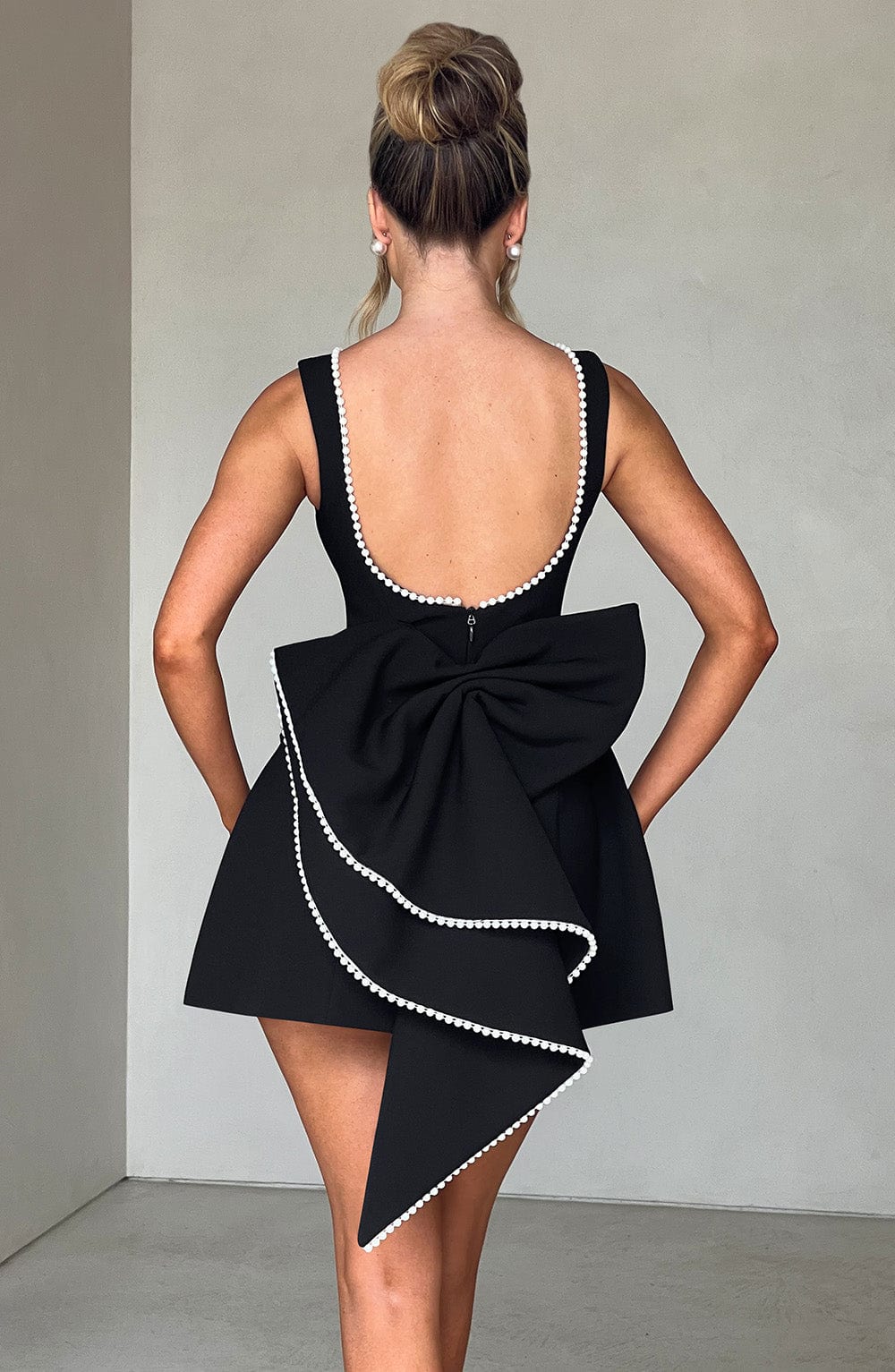 Flowy A-line mini dress with elegant pearl trim for women, a comfortable and stylish choice for summer party wear.