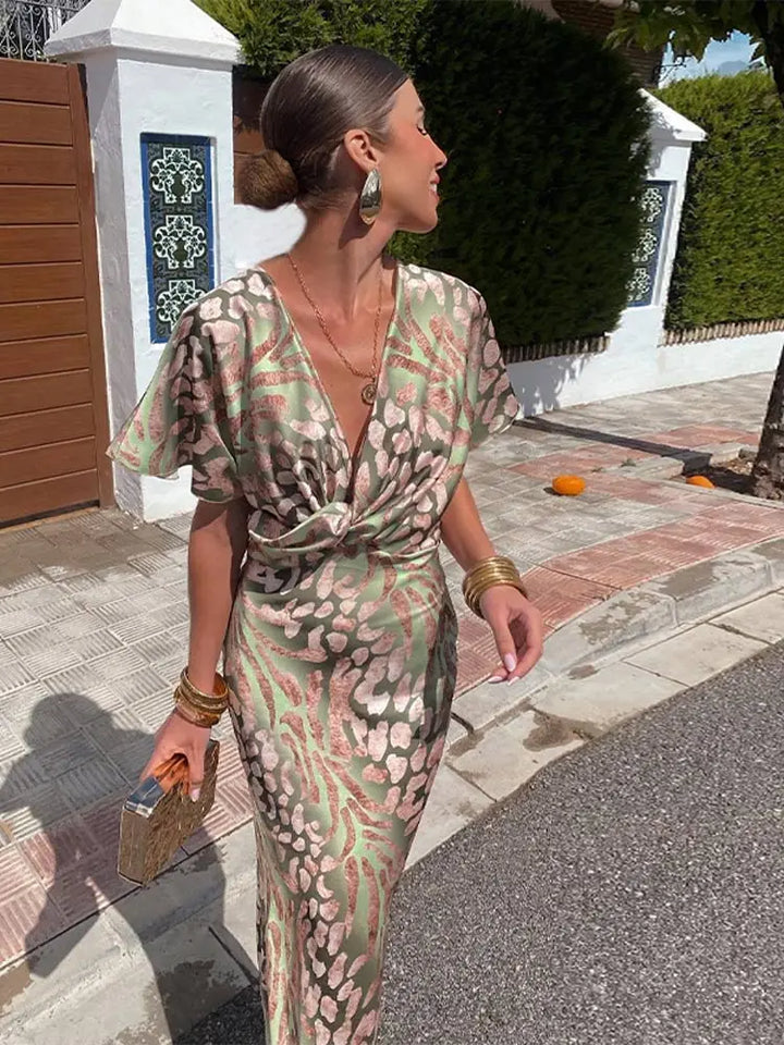 Chic women's animal print maxi dress featuring a trendy wrap design, twist front, and elegant fluted sleeves.