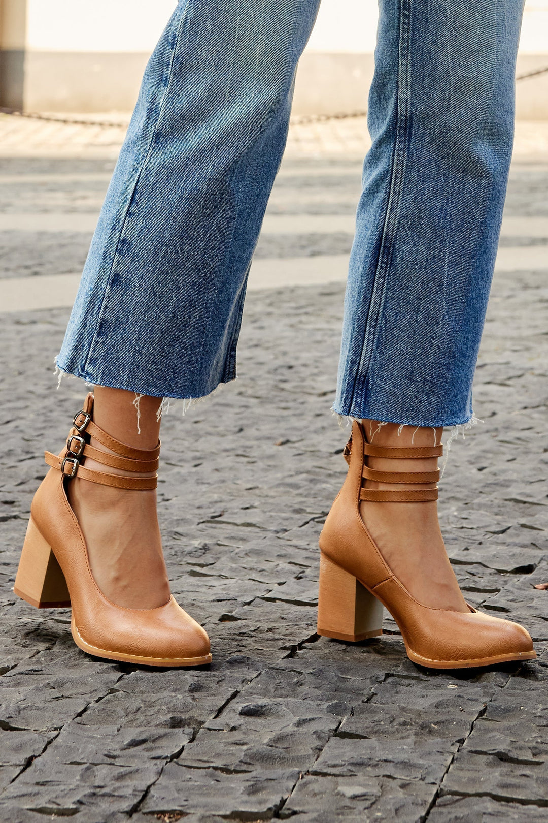 Comfortable women's block heels featuring an elegant ankle strap and classic closed toe design.
