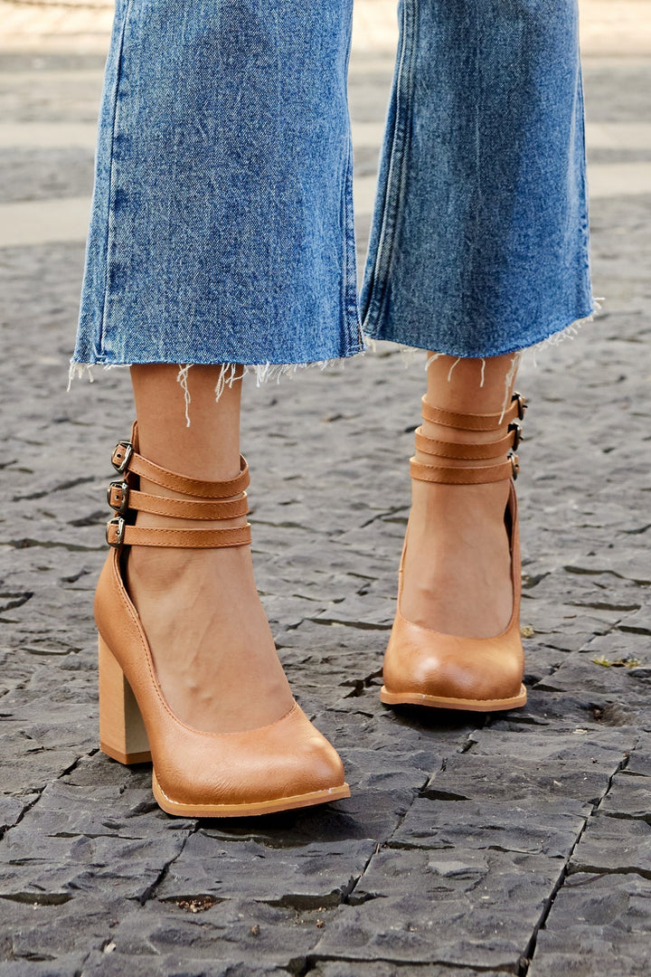 Side view: Elegant black ankle strap block heels with a comfortable closed toe. Perfect dress footwear.