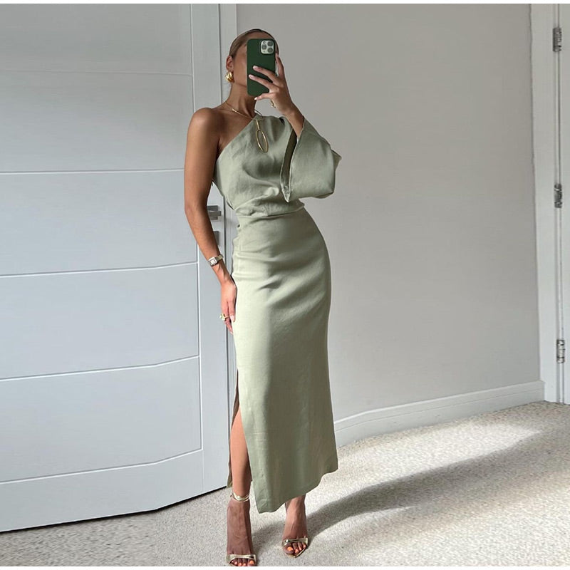 Elegant women's asymmetrical one-shoulder maxi dress. Flowing fabric, modern style, perfect for summer occasions.