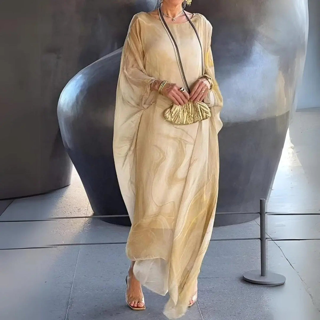 Elegant women's batwing long sleeve maxi dress for special occasions. Floaty evening gown with round neck.