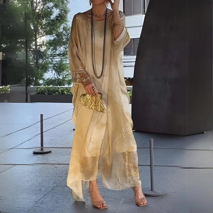 Floaty women's maxi dress with elegant batwing long sleeves, perfect as an occasion or evening gown.
