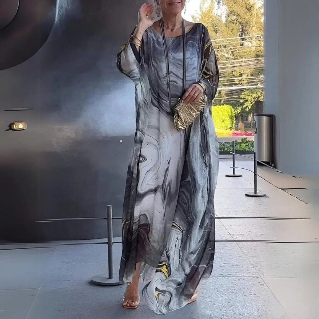Sophisticated women's batwing long sleeve maxi gown. Elegant round neck floaty dress for evening events.