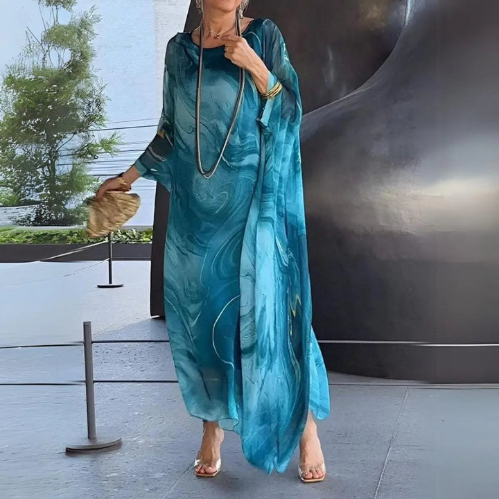 Plus size elegant floaty maxi dress for women, featuring batwing long sleeves. Ideal for special occasions.
