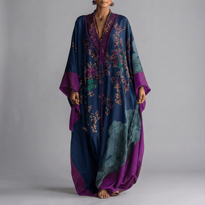Women's long batwing dress featuring a delicate plum blossom floral print. Versatile for elegant summer occasions.