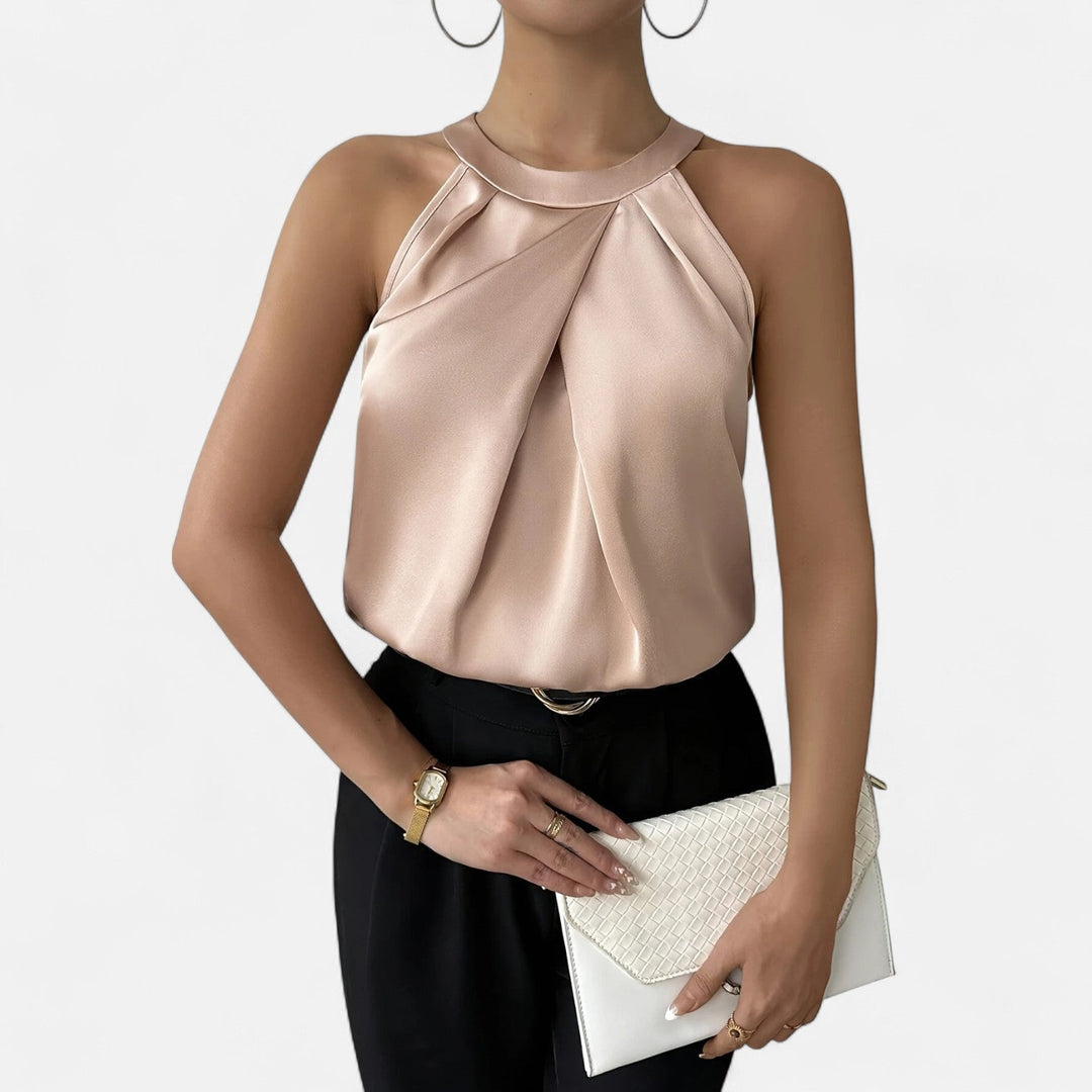Elegant women's beige halter neck top with pleated wrap front, sleeveless for a sophisticated party or casual chic look.
