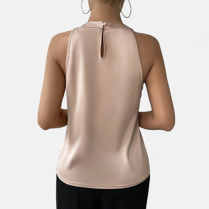 Stylish beige halter neck sleeveless top for women, featuring a chic pleated wrap front, perfect for elegant wear.