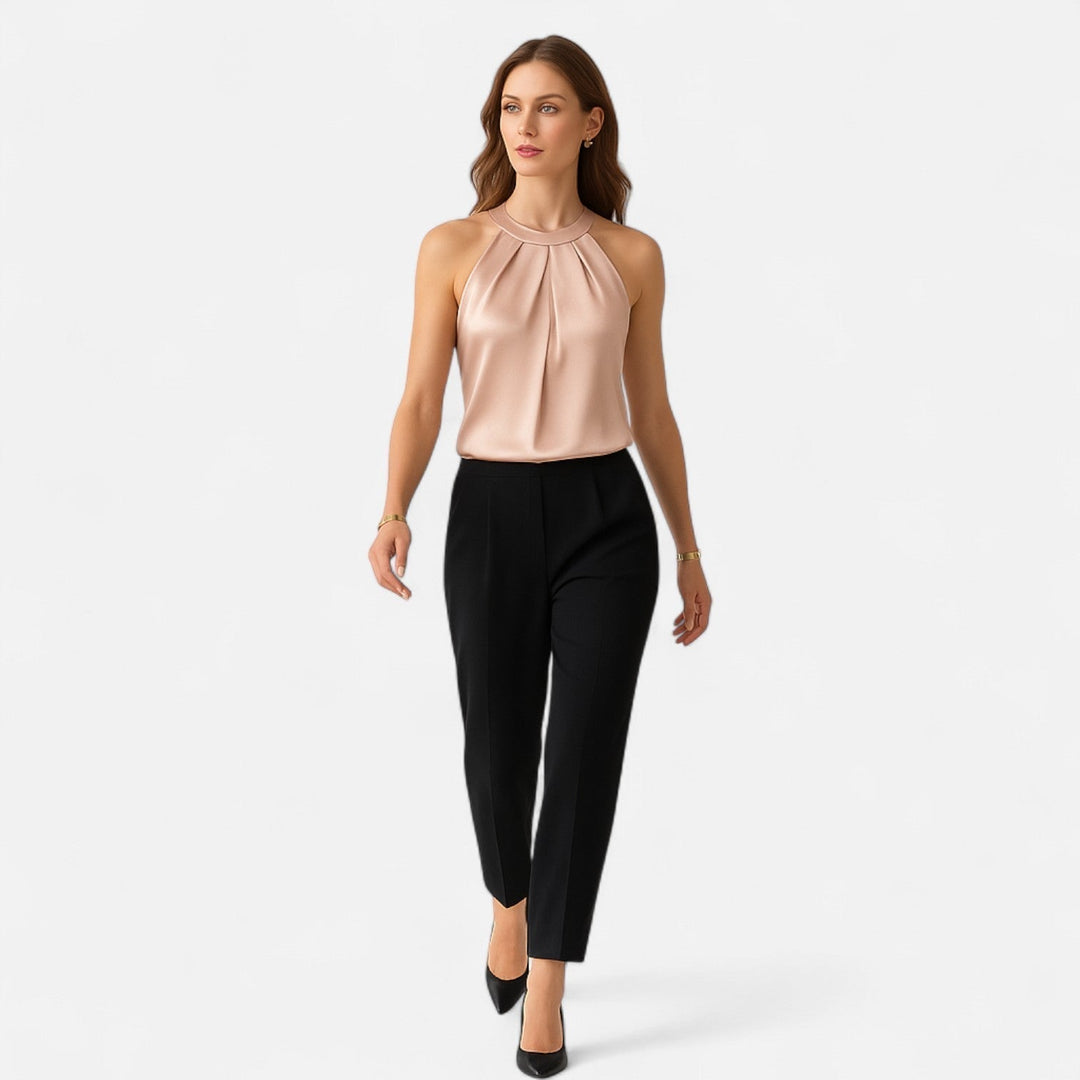 Sophisticated women's beige top with a halter neck, sleeveless design & elegant pleated wrap front, ideal for parties.