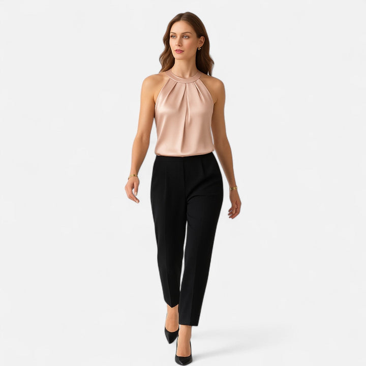 Sophisticated women's beige top with a halter neck, sleeveless design & elegant pleated wrap front, ideal for parties.