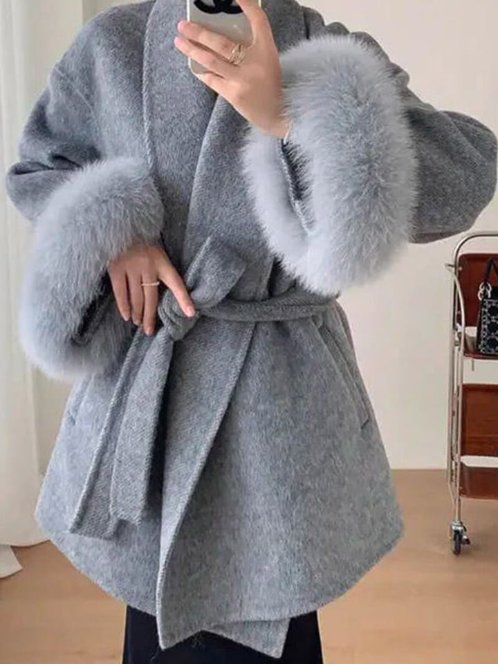 Sophisticated women's belted wrap coat, perfect for cold weather, with plush faux fur cuffs.