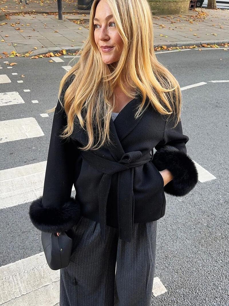 Women's elegant belted wrap coat, perfect for winter, featuring luxurious faux fur cuffs.