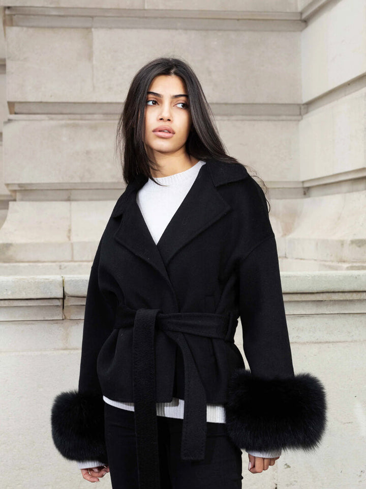 Sophisticated women's jacket: belted wrap design, shawl collar, and luxurious faux fur cuffs.