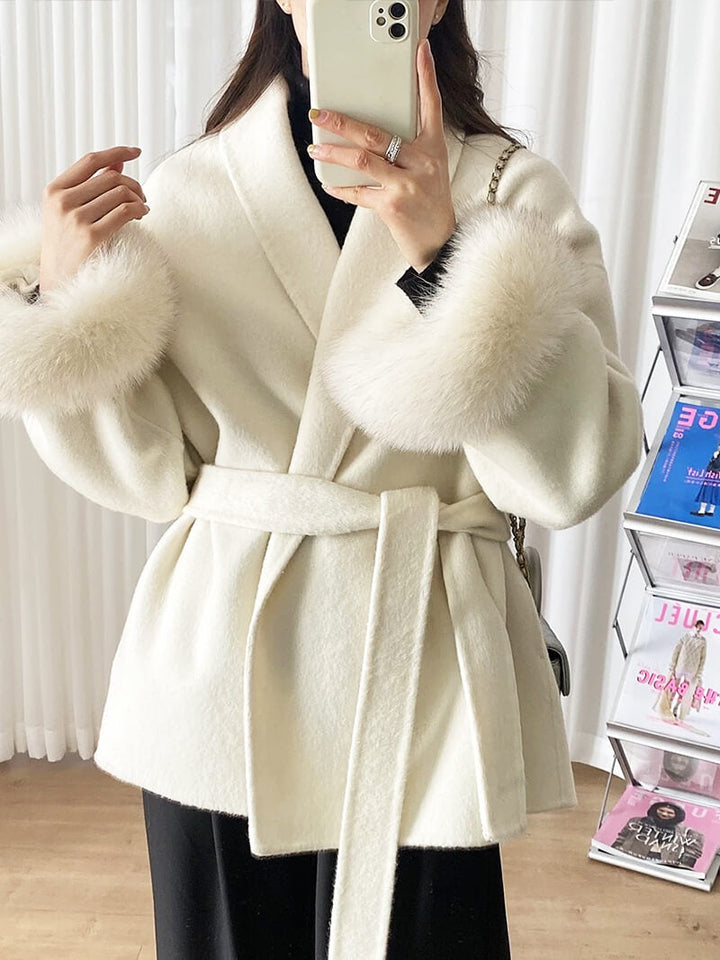 Luxurious women's winter jacket with a chic wrap design, belted waist, and soft faux fur cuffs.