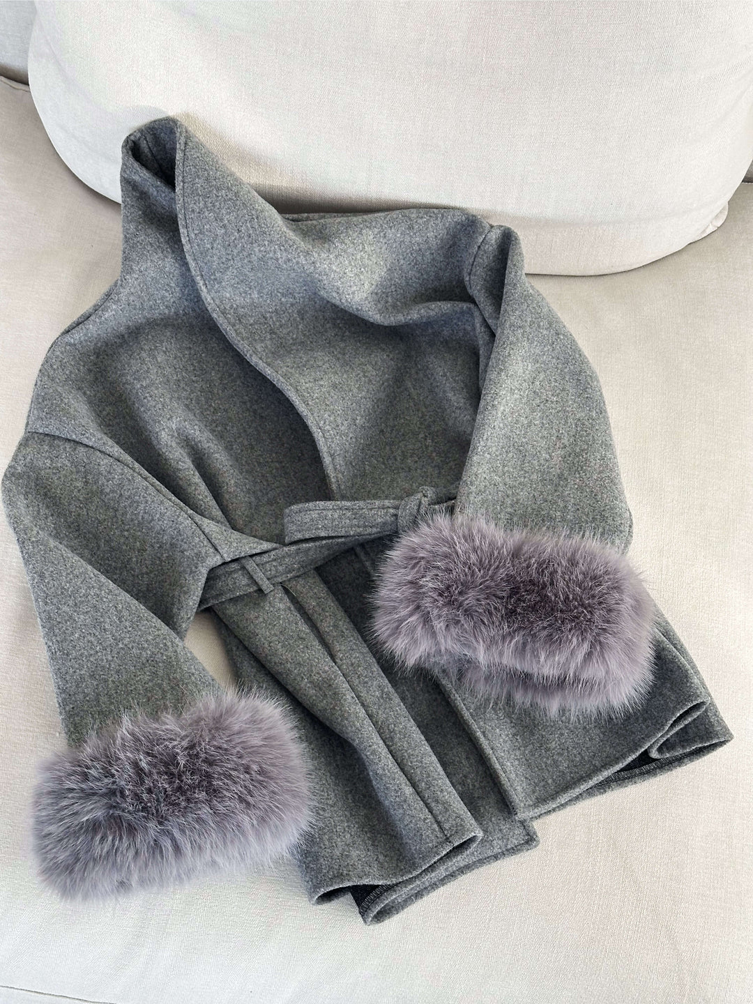 Classic women's wrap coat in a sophisticated style, with a matching belt and luxurious faux fur cuffs.