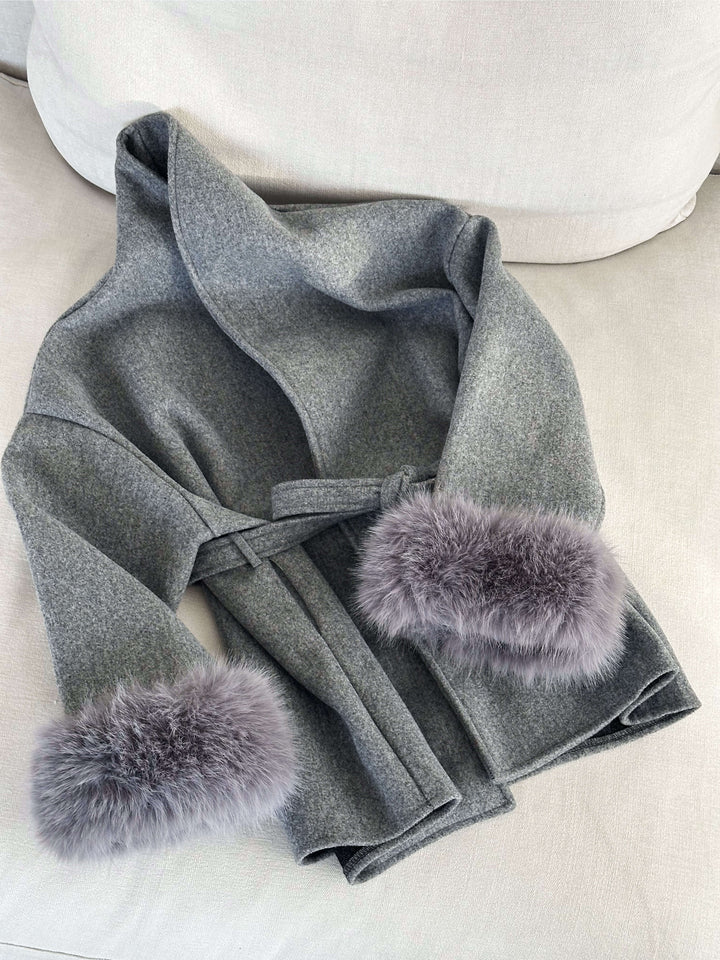 Classic women's wrap coat in a sophisticated style, with a matching belt and luxurious faux fur cuffs.