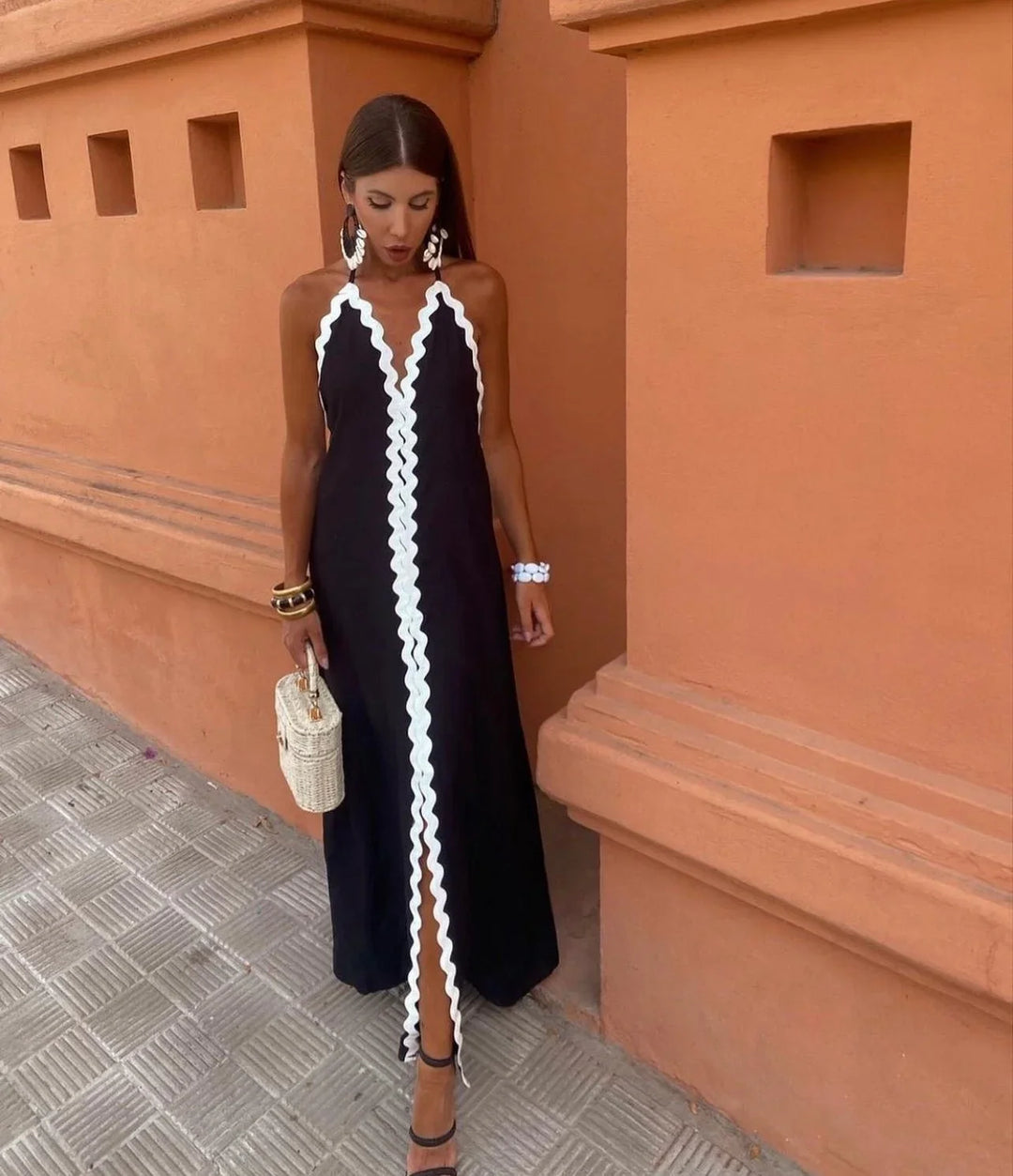 Elegant women's black and white wedding guest maxi wrap dress with halter V-neck. Perfect for formal occasions.