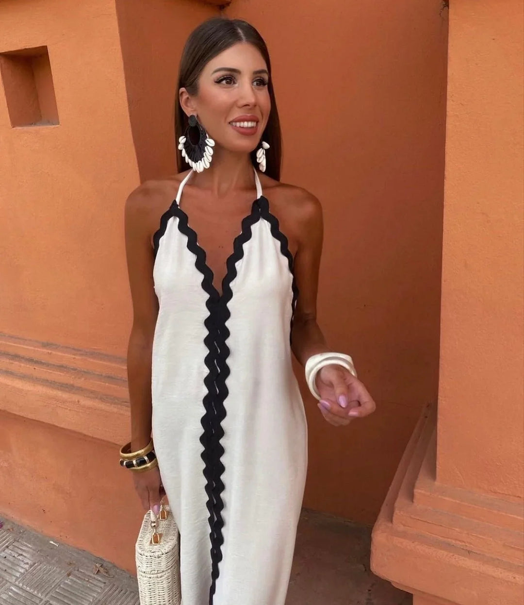 Women's flattering black & white wrap maxi dress with a sophisticated halter V-neck. Ideal formal party wear.