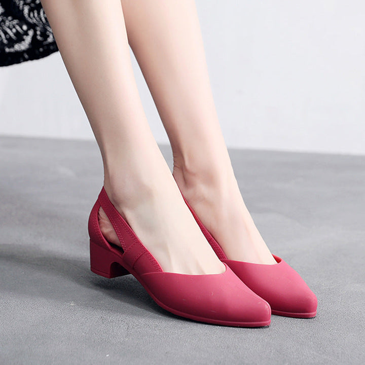 Fashionable women's black block heel pumps with chic cutouts, great for elegant office wear.