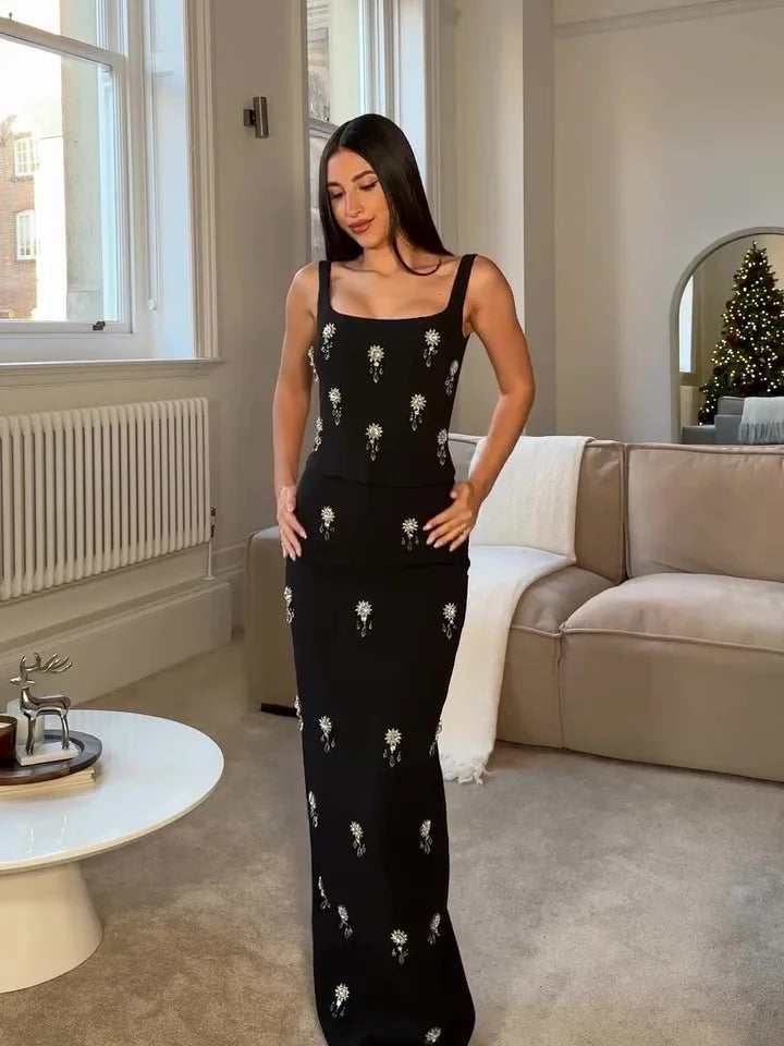 Stunning sleeveless black maxi dress for women featuring a square neck and delicate crystal embellishments. Formalwear.