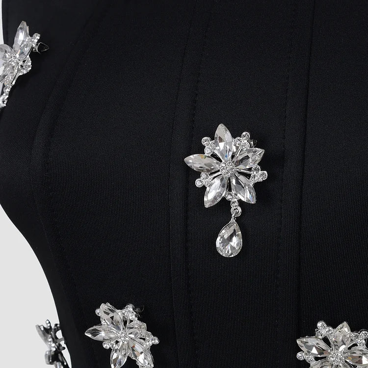 Elegant black crystal embellished women's maxi dress with square neck. Sleeveless formal evening gown for special occasions.
