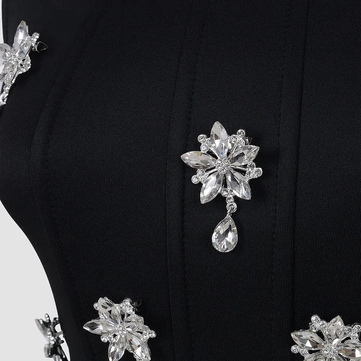 Elegant black crystal embellished women's maxi dress with square neck. Sleeveless formal evening gown for special occasions.