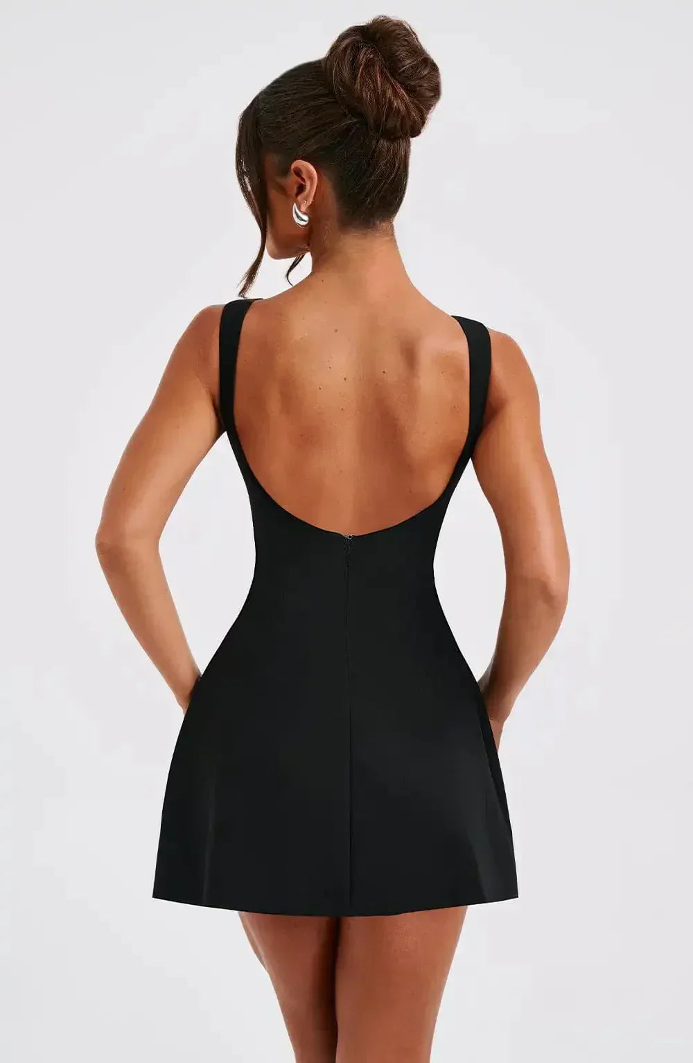 Women's A-line boat neck mini dress in black & white. Sleeveless and chic, ideal for cocktail parties.