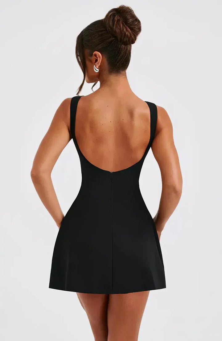 Women's A-line boat neck mini dress in black & white. Sleeveless and chic, ideal for cocktail parties.