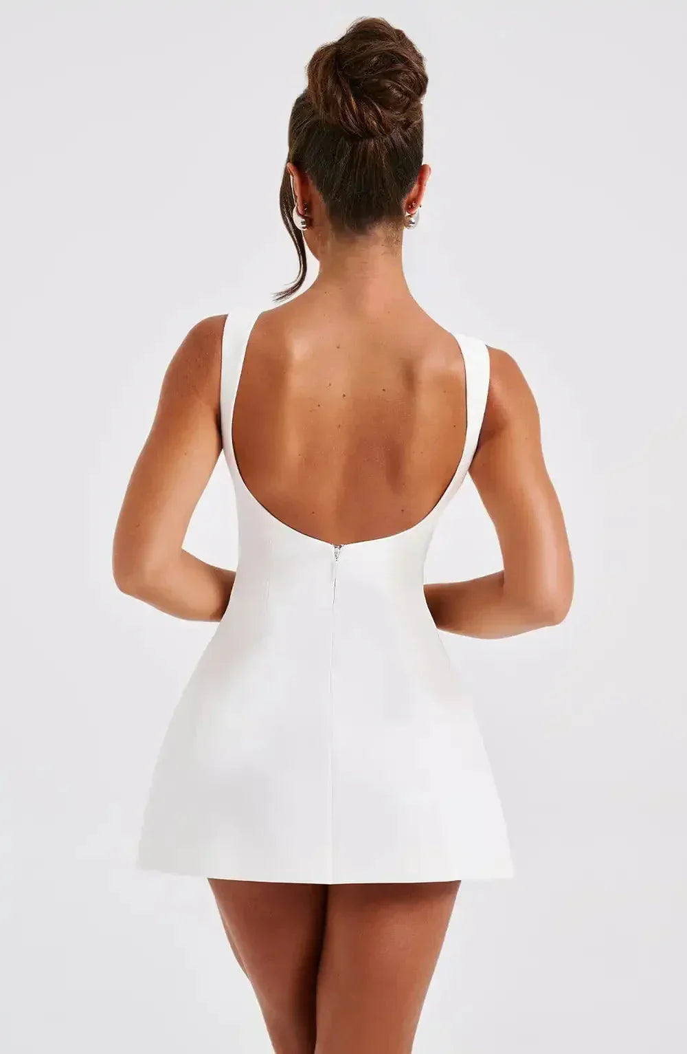 Versatile women's A-line mini dress with boat neck, black & white. Elegant sleeveless cocktail party attire.