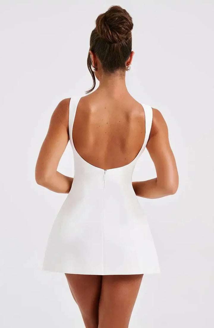 Versatile women's A-line mini dress with boat neck, black & white. Elegant sleeveless cocktail party attire.