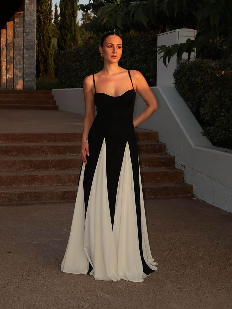 Formal women's black and white maxi dress with elegant contrast design & open back detail.