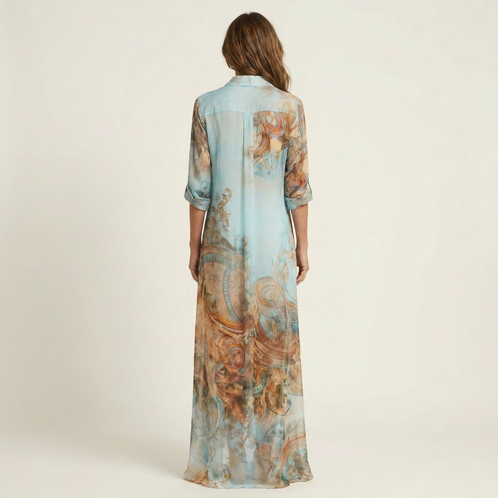 Women's button-front maxi shirt dress featuring a vibrant blue baroque print, ideal for elegant evening or vacation style.