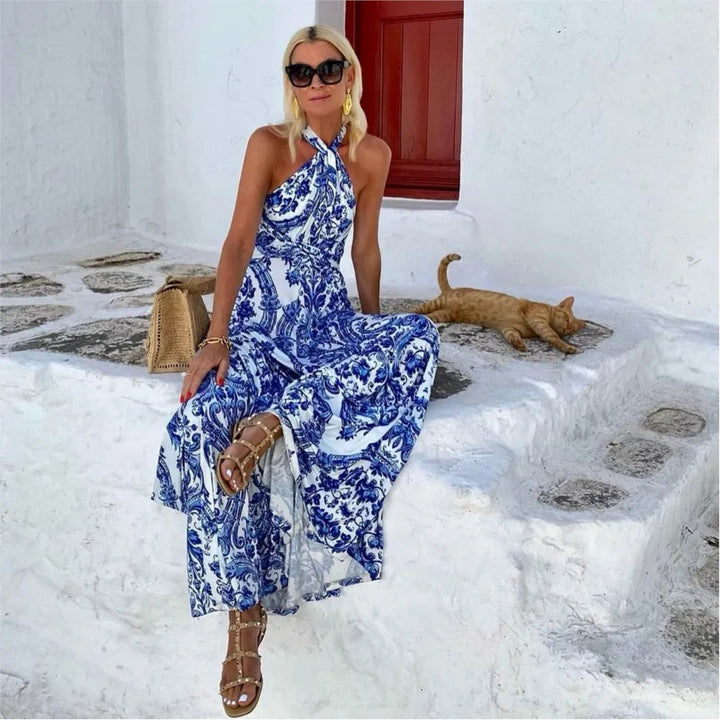 Flowy women's halter A-line maxi sundress in blue. Comfortable sleeveless summer dress for beach, resort, or everyday style.