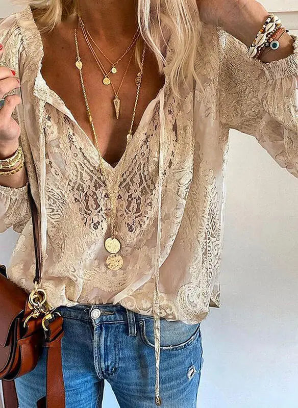 Chic women's boho blouse featuring an elegant cutout neckline & long sleeves, ideal for versatile summer fashion.