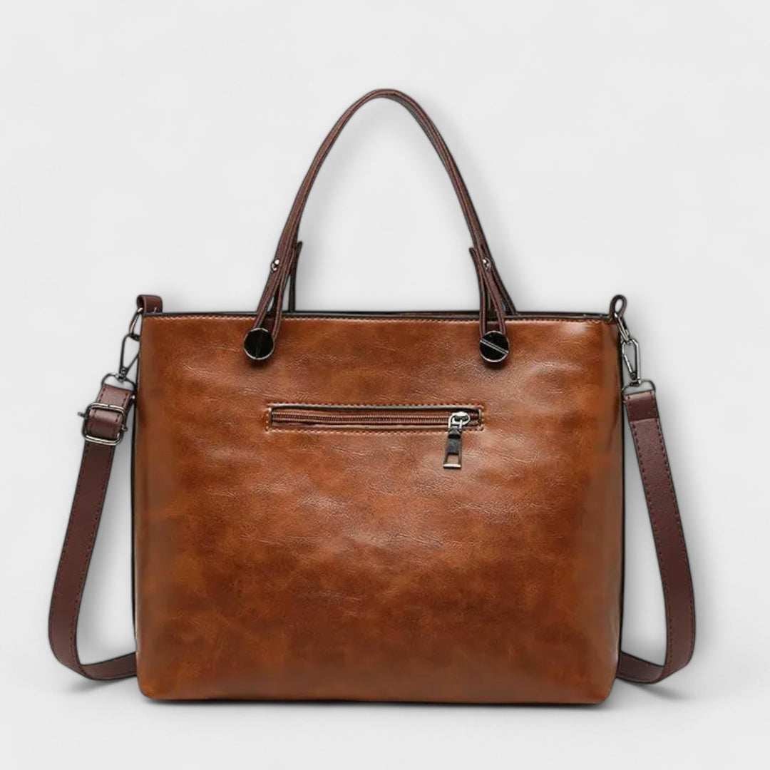 Sleek black leather shoulder bag. Elegant women's everyday bag, perfect for work or travel with a classic style.