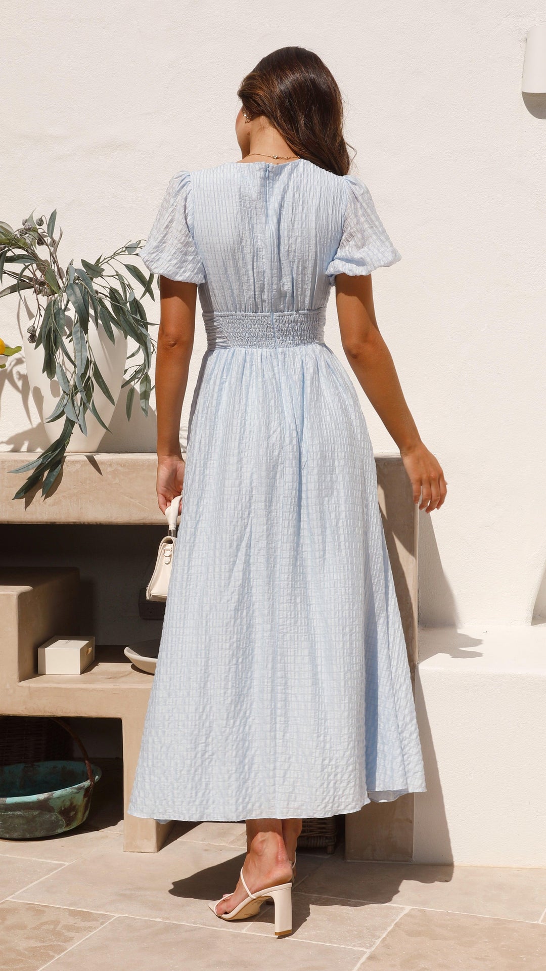 Long women's summer maxi dress with button-front and flowy design, offering casual elegance for any occasion.