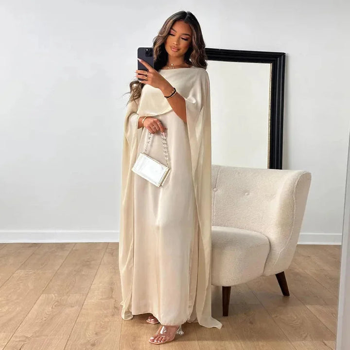 Elegant women's cape maxi dress, perfect for wedding guests & formal occasions. Chic long evening gown.