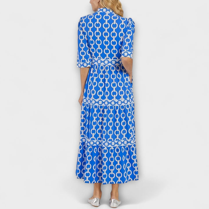 Classy women's midi dress featuring a striking chain print, collared, and full button-front.